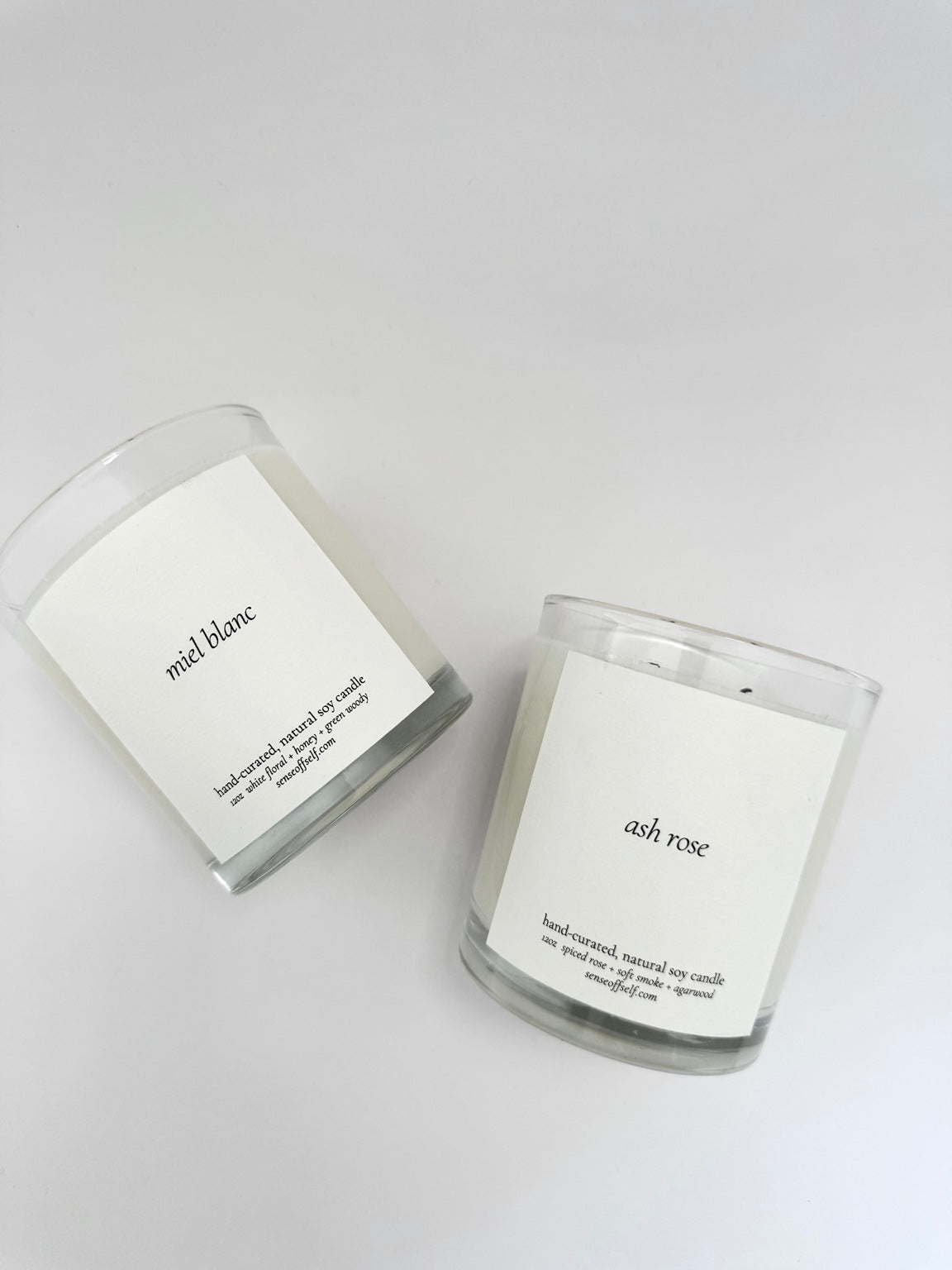 Sense of Self Miel Blanc and Ash Rose soy candles on a light gray background
